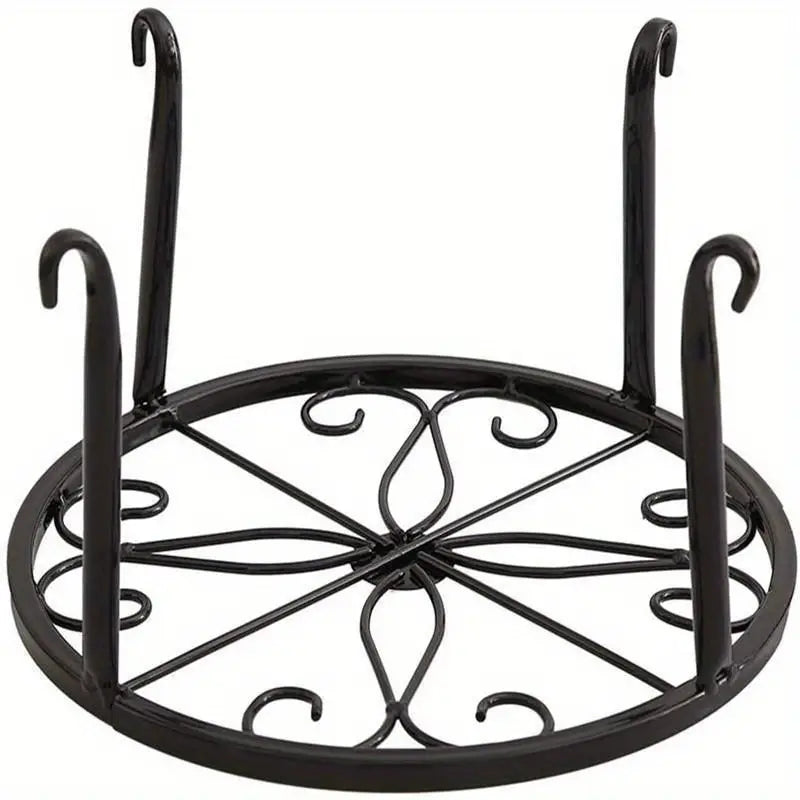 a black heavy-duty metal plant stand with a circular top and four curved legs.