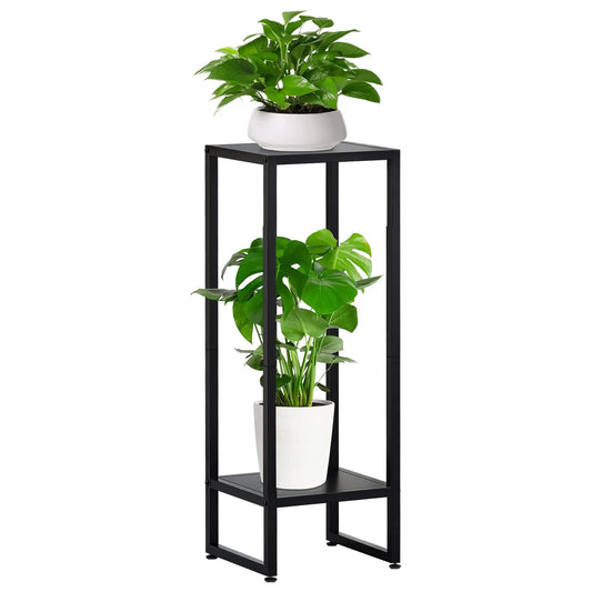 A black metal plant stand featuring two levels. The top level holds a white pot with lush green leaves, while the bottom level houses a white pot with large green leaves.