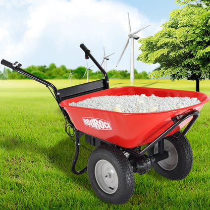 A Red electric wheelbarrow filled with gravel, positioned in a lush green field with wind turbines in the background, showcasing its eco-friendly and versatile utility